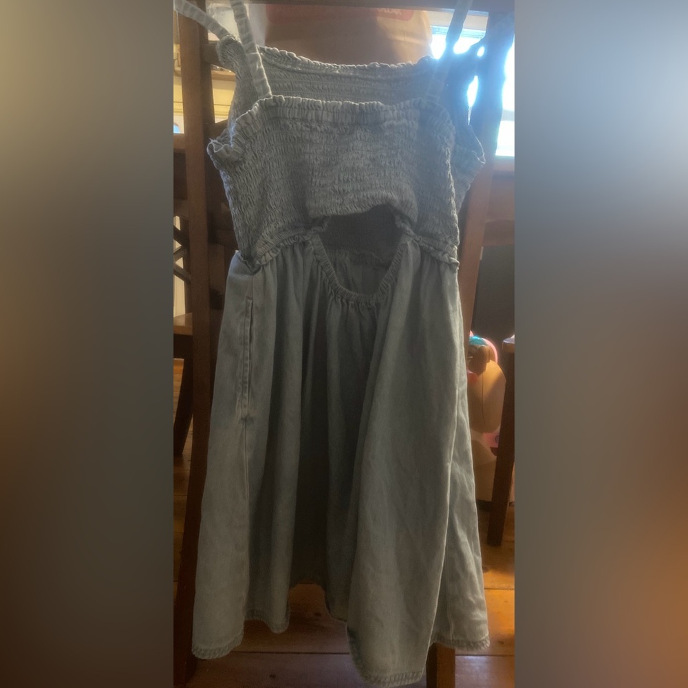 Women’s blue denim mini dress. Never worn (NWOT) hole in the back